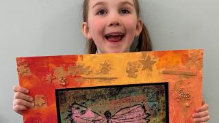 Happy girl showing picture.