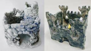 Kaksi keramiikka lumilinnaa.