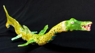 Keltavihreä trooppinen eläin.